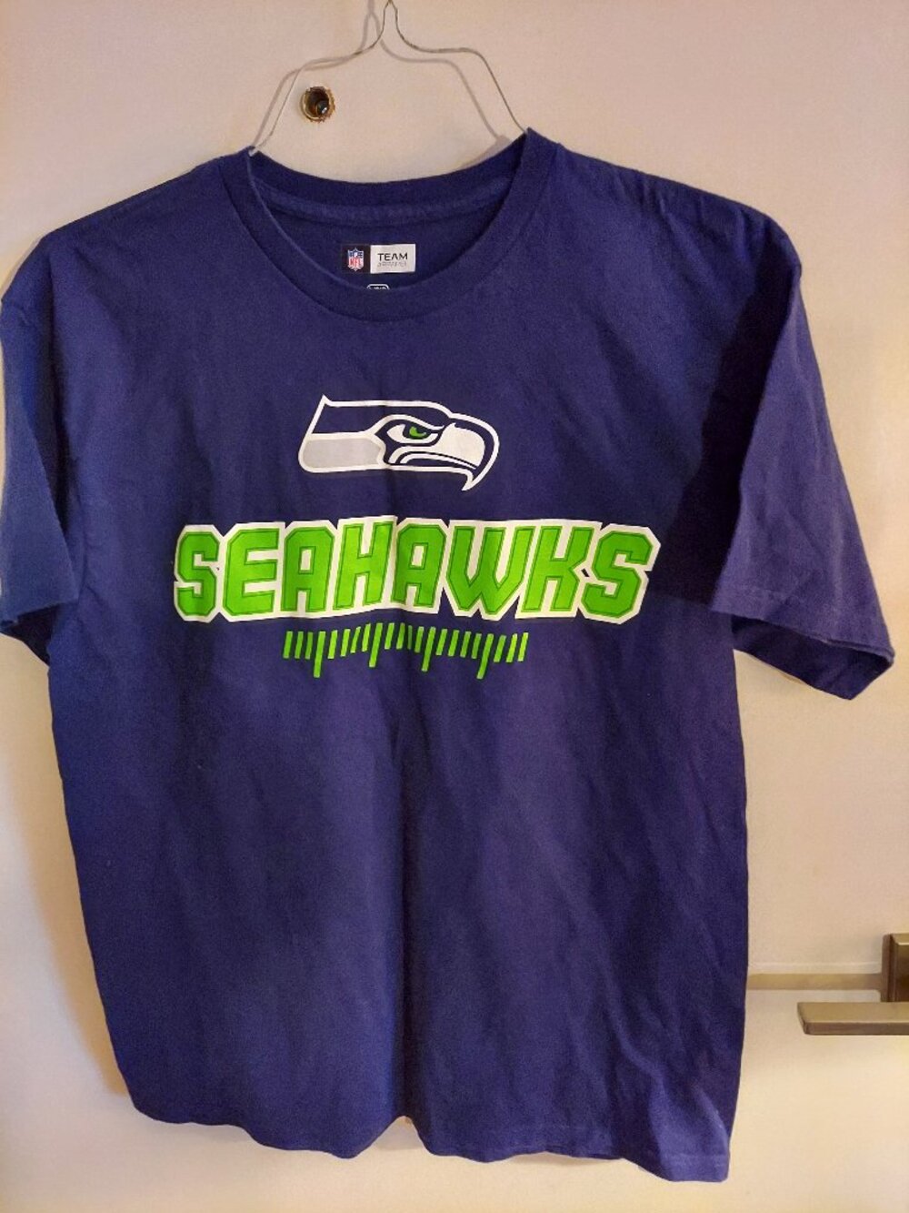 NFL Team Apparel, blue t-shirt with SEAHAWKS artwork on front, short sleeves